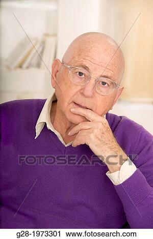 Senior Man in a purple pullover and shirt, finger in front of mouth, wearing spectacles, in a thoughtful puzzled mood View Large Photo Image Stock Image - Senior Man in a purple pullover and shirt, finger in front of mouth, wearing spectacles, in a thoughtful puzzled mood. Fotosearch