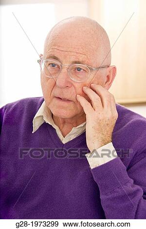 Senior man in a purple pullover and shirt, hand on cheek, wearing spectacles, in a thoughtful puzzled mood View Large Photo Image Stock Photo - Senior man in a purple pullover and shirt, hand on cheek, wearing spectacles, in a thoughtful puzzled mood. Fotosearch