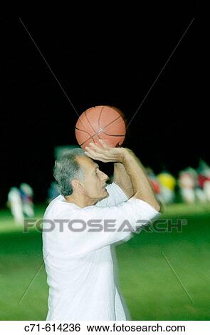Senior man playing basketball View Large Photo Image Stock Photograph - Senior man playing basketball. Fotosearch