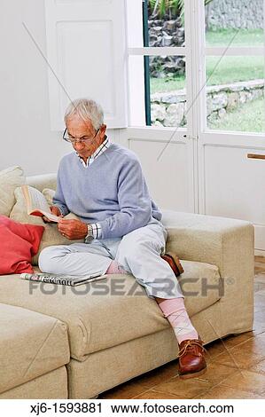 Stock Image - Senior man reading book. Fotosearch