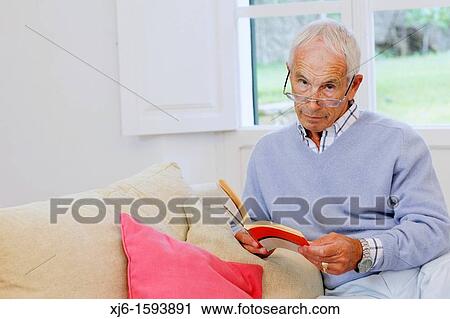 Senior man reading book View Large Photo Image Stock Image - Senior man reading book. Fotosearch