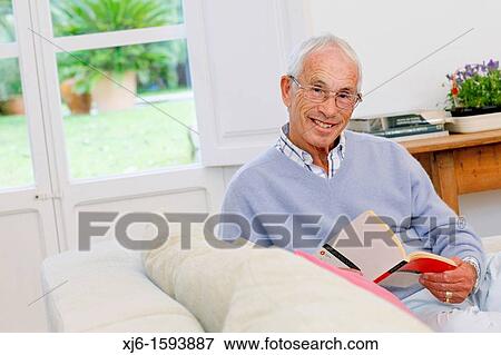 Senior man reading book View Large Photo Image Stock Photo - Senior man reading book. Fotosearch