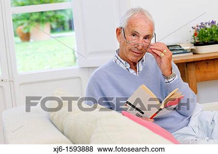 Senior man reading book View Large Photo Image Stock Photo - Senior man reading book. Fotosearch