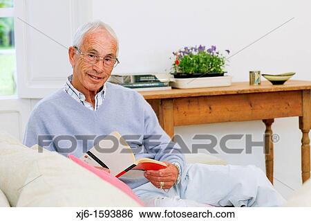 Senior man reading book View Large Photo Image Stock Photograph - Senior man reading book. Fotosearch