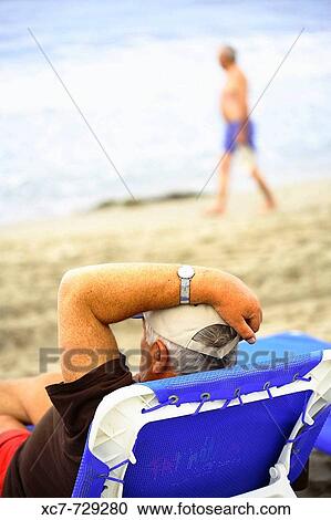 Senior man resting on beach. Benidorm, Comunidad Valenciana, Spain View Large Photo Image Stock Image - Senior man resting on beach. Benidorm, Comunidad Valenciana, Spain. Fotosearch