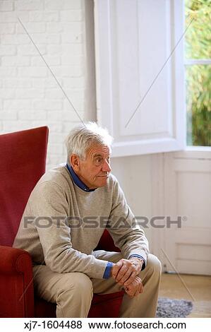 Senior man sitting at home View Large Photo Image Stock Photo - Senior man sitting at home. Fotosearch