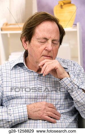 senior man sitting inside resting and having a nap View Large Photo Image Stock Photo - senior man sitting inside resting and having a nap. Fotosearch
