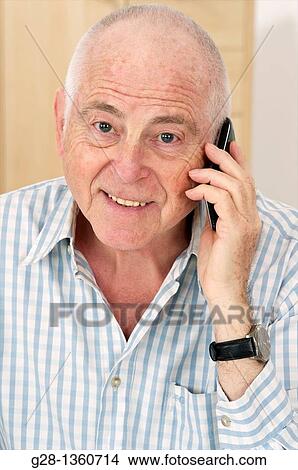 Senior man using a cell phone looking happy View Large Photo Image Picture - Senior man using a cell phone looking happy. Fotosearch