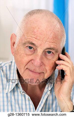 Senior man using a cell phone looking serious View Large Photo Image Stock Photography - Senior man using a cell phone looking serious. Fotosearch