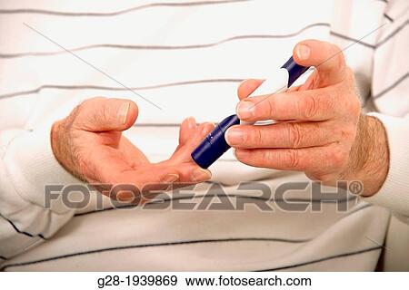 Senior man using a self Blood pen, to sample sugar rate in blood, to treat his diabetes View Large Photo Image Stock Photo - Senior man using a self Blood pen, to sample sugar rate in blood, to treat his diabetes. Fotosearch
