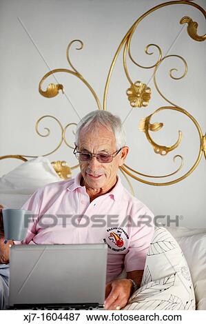 Stock Photo - Senior man using laptop computer. Fotosearch