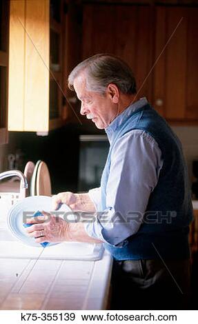 Senior man washing dishes View Large Photo Image Stock Photo - Senior man washing dishes. Fotosearch