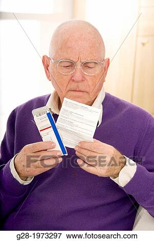 Senior man wearing glasses, looking puzzled and worried reading a prescription which he is holding in his hand View Large Photo Image Stock Photo - Senior man wearing glasses, looking puzzled and worried reading a prescription which he is holding in his hand. Fotosearch