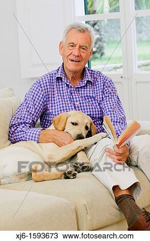 Stock Image - Senior man with dog. Fotosearch