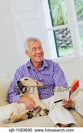 Stock Image - Senior man with dog. Fotosearch