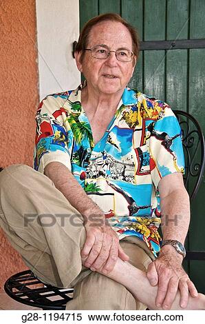 Senior man with glasses sitting and holding his foot and leg View Large Photo Image Stock Photography - Senior man with glasses sitting and holding his foot and leg. Fotosearch