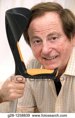 senior man with his hands resting on his crutch View Large Photo Image Stock Photo - senior man with his hands resting on his crutch. Fotosearch