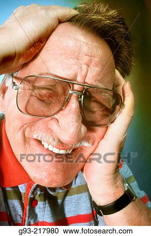 Stock Image - Senior man with peasent overwhelmed look. Fotosearch