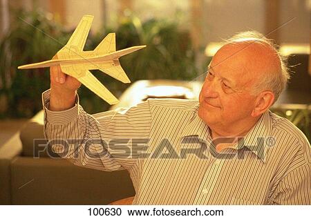 Senior man with toy airplane View Large Photo Image Stock Image - Senior man with toy airplane. Fotosearch