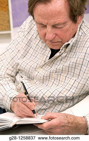 Stock Photo - senior man writing in his diary concept Alzheimer. Fotosearch