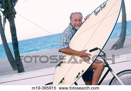senior surfer on his bicycle with surfboard View Large Photo Image Stock Photography - senior surfer on his bicycle with surfboard. Fotosearch