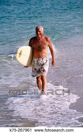 Stock Image - Senior surfer. Fotosearch