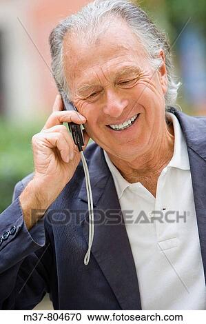 Stock Image - Senior talking to cell phone. Rome, Italy. Fotosearch