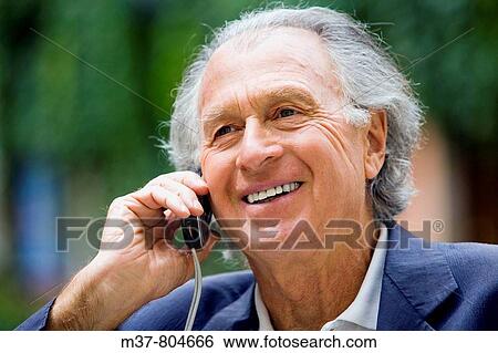 Stock Photograph - Senior talking to cell phone. Rome, Italy. Fotosearch