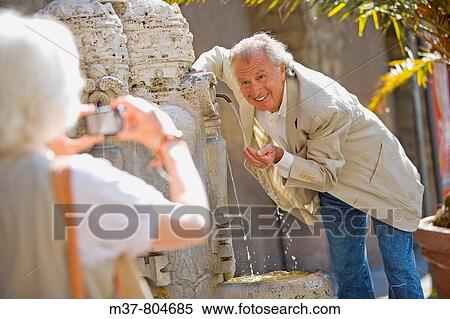 Senior tourists at the Pope fountain in St Peter's Square, Rome, Italy View Large Photo Image Stock Photography - Senior tourists at the Pope fountain in St Peter's Square, Rome, Italy. Fotosearch