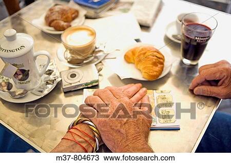 Stock Image - Senior tourists having breakfast. Rome, Italy. Fotosearch
