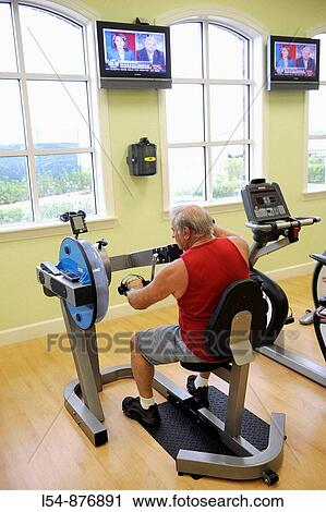 Senior white man on upper body exercise machine in fitness center View Large Photo Image Stock Image - Senior white man on upper body exercise machine in fitness center. Fotosearch
