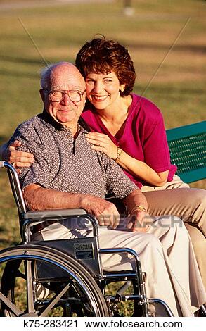 Senior with his caretaker in the park View Large Photo Image Stock Image - Senior with his caretaker in the park. Fotosearch