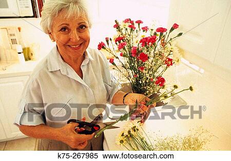 Senior woman and her bouquet of flowers View Large Photo Image Stock Photography - Senior woman and her bouquet of flowers. Fotosearch