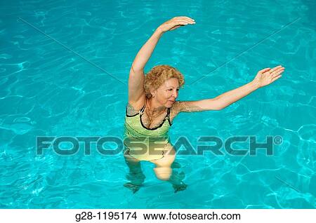 senior woman doing aquagym in a swimming pool View Large Photo Image Picture - senior woman doing aquagym in a swimming pool. Fotosearch