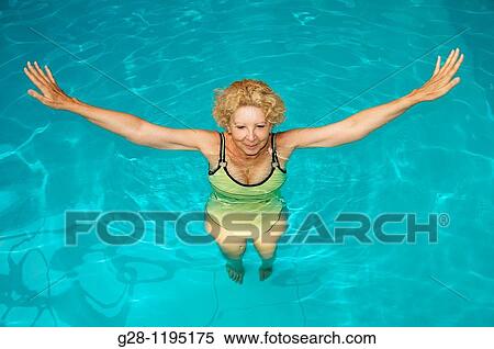 senior woman doing aquagym in a swimming pool View Large Photo Image Stock Photography - senior woman doing aquagym in a swimming pool. Fotosearch