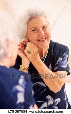 Picture - Senior woman getting ready for a night out. Fotosearch