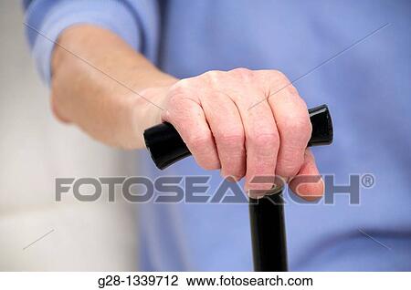 senior woman hand holding a walking stick detail View Large Photo Image Stock Image - senior woman hand holding a walking stick detail. Fotosearch
