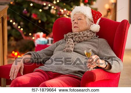Senior woman having a catnap at Christmas time View Large Photo Image Picture - Senior woman having a catnap at Christmas time. Fotosearch