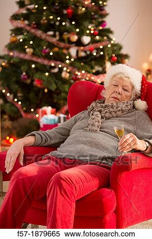Senior woman having a catnap at Christmas time View Large Photo Image Stock Photography - Senior woman having a catnap at Christmas time. Fotosearch