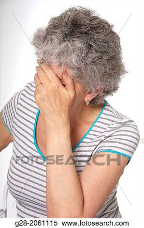 Senior woman, holding her face in her hand, with closed eyes, feeling, dizzy, or tired, or sad, suffering from depression or from a headache View Large Photo Image Stock Photography - Senior woman, holding her face in her hand, with closed eyes, feeling, dizzy, or tired, or sad, suffering from depression or from a headache. Fotosearch