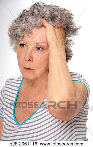 Senior woman holding her head, feeling, dizzy, or tired, or sad, suffering from depression, or from a headache View Large Photo Image Stock Photograph - Senior woman holding her head, feeling, dizzy, or tired, or sad, suffering from depression, or from a headache. Fotosearch