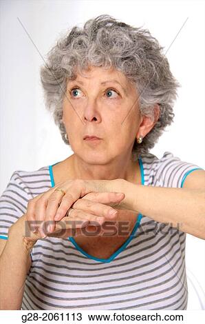 Senior woman holding her painful hands, and fingers, from rheumatism View Large Photo Image Stock Image - Senior woman holding her painful hands, and fingers, from rheumatism. Fotosearch
