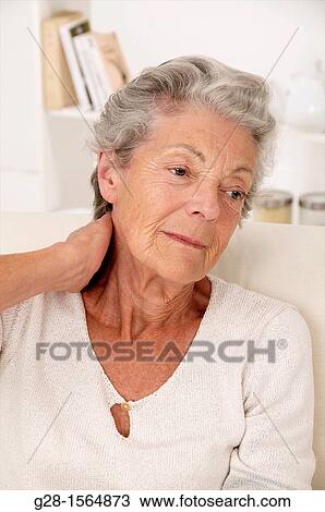 Senior woman holding her painful neck from rheumatism View Large Photo Image Stock Image - Senior woman holding her painful neck from rheumatism. Fotosearch