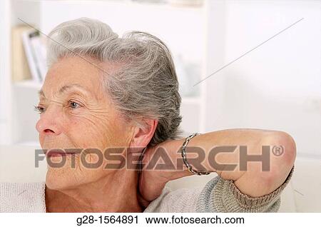 Senior woman holding her painful neck from rheumatism View Large Photo Image Stock Image - Senior woman holding her painful neck from rheumatism. Fotosearch