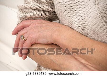 senior woman holding one of her painful elbow detail View Large Photo Image Stock Photo - senior woman holding one of her painful elbow detail. Fotosearch