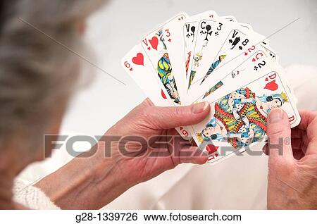 senior woman in beige playing cards at home View Large Photo Image Stock Photograph - senior woman in beige playing cards at home. Fotosearch