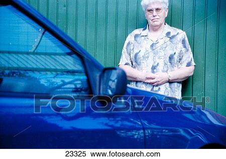 Senior woman in front of car View Large Photo Image Stock Photography - Senior woman in front of car. Fotosearch