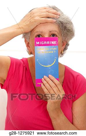 senior woman in pink, suffering from a headache and holding a medical leaflet on headache migraine View Large Photo Image Stock Image - senior woman in pink, suffering from a headache and holding a medical leaflet on headache migraine. Fotosearch