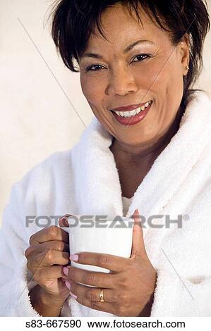 Senior woman in robe drinking coffee View Large Photo Image Stock Image - Senior woman in robe drinking coffee. Fotosearch