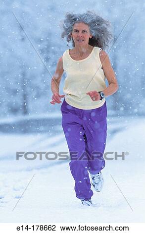 Senior woman jogging in snow. Alaska. USA View Large Photo Image Stock Image - Senior woman jogging in snow. Alaska. USA. Fotosearch